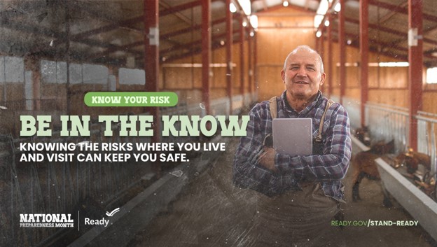 Promotional graphic for National Preparedness Month showing a person standing in a barn holding a notebook. Text reads “Know Your Risk. Be in the Know. Knowing the risks where you live and visit can keep you safe.” Logos for National Preparedness Month and Ready.gov appear at the bottom.